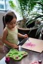 Toddler painting on the recycled cardboard at home
