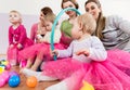 Toddler in pink dress playing with hula hoop