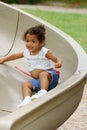 Toddler on playground slide Royalty Free Stock Photo