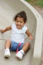 Toddler on playground slide Royalty Free Stock Photo