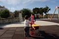 Toddler playing alone in the park - lonely child