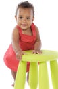 Toddler playing with a chair Royalty Free Stock Photo