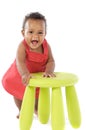 Toddler playing with a chair Royalty Free Stock Photo