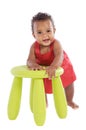 Toddler playing with a chair Royalty Free Stock Photo