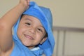 Toddler playing and hiding on his blue T-shirt. Royalty Free Stock Photo