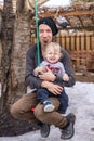 Toddler playing outdoor with dad on a swing Royalty Free Stock Photo