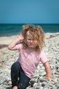 Toddler playing on a pebbled beach Royalty Free Stock Photo