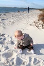 Toddler playing on sandy beach