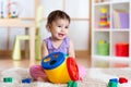 Toddler playing with a shape sorter