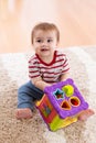 Toddler playing with a shape sorter