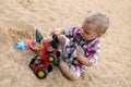 Toddler playing with toy bulldozer