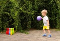 Toddler plays active outdoors games. bowling pins Royalty Free Stock Photo
