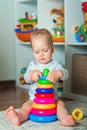 Toddler plays colorful home constructor and copy space. Development of children from birth