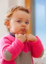 Toddler plays making bubbles with her mouth