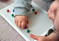 Toddler plays with pins