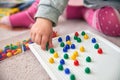 Toddler plays with pins