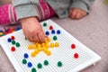 Toddler plays with pins