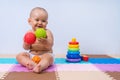 A toddler plays with rubber balls to develop hand motor skills Royalty Free Stock Photo