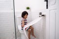 Toddler pulling out toilet paper Royalty Free Stock Photo