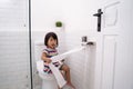 Toddler pulling out toilet paper Royalty Free Stock Photo