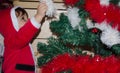 Toddler putting christmas decoration on christmas tree