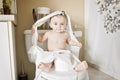 Toddler ripping up toilet paper in bathroom