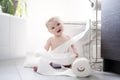 Toddler ripping up toilet paper in bathroom Royalty Free Stock Photo