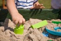 Toddler`s hands playing with kinetic sand outdoors. Child making shapes. Lifestyle and summer concept Royalty Free Stock Photo