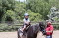 Toddler with a Safety Helmet on Goes on a Pony Ride at a Local Farm with his Horse Being Led Grandfather Royalty Free Stock Photo