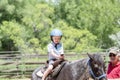 Toddler with a Safety Helmet on Goes on a Pony Ride at a Local Farm with his Horse Being Led Grandfather Royalty Free Stock Photo