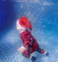 Little baby as elf with mother in red swimming suit swimming underwater Royalty Free Stock Photo