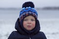 Toddler with snivel and red cheeks. Outdoor winter shot