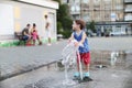 Toddler and a splashing water fountain Royalty Free Stock Photo