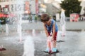 Toddler and a splashing water fountain Royalty Free Stock Photo