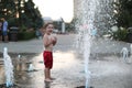 Toddler and a splashing water fountain Royalty Free Stock Photo