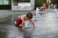 Toddler and a splashing water fountain Royalty Free Stock Photo