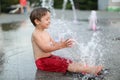 Toddler and a splashing water fountain Royalty Free Stock Photo