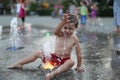 Toddler and a splashing water fountain Royalty Free Stock Photo
