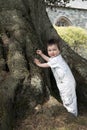 Toddler standing by tree Royalty Free Stock Photo