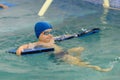 Toddler swimming training in the pool. Swimming training for a child. Royalty Free Stock Photo