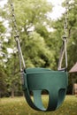 EMPTY CHILDS TODDLER SWING ON CHAINS Royalty Free Stock Photo