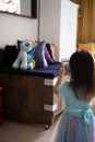 Toddler taking photo of her plush toys using the mobile phone. Kid using technology