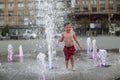 Toddler walking in a splashing water fountain Royalty Free Stock Photo