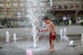 Toddler walking in a splashing water fountain Royalty Free Stock Photo