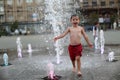 Toddler walking in a splashing water fountain Royalty Free Stock Photo