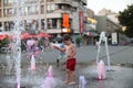 Toddler walking in a splashing water fountain Royalty Free Stock Photo