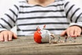 Toddler watching miniature people breaking an egg