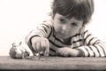 Toddler watching miniature people cracking an egg