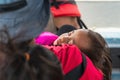 Toddler wearing life jacket sleeping on a moving boat while cruising a lake in Kenyir, Terengganu, Malaysia Royalty Free Stock Photo