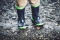 Toddler wearing rubber boots in rainy weather